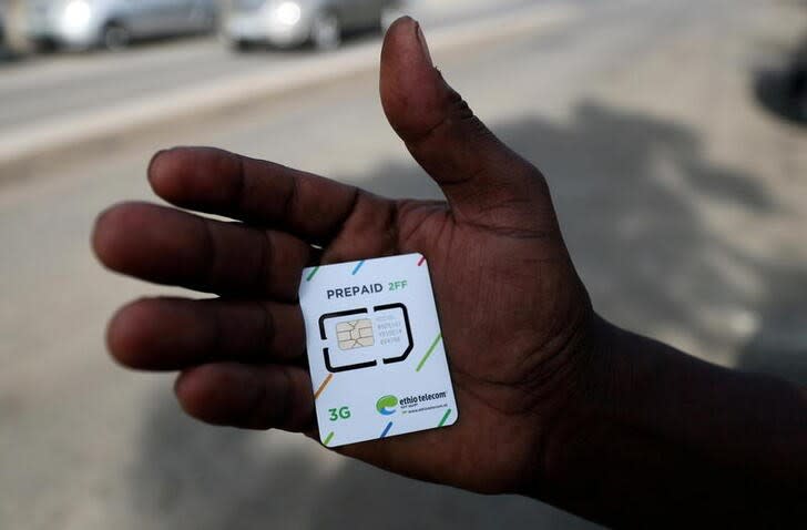 FILE PHOTO: A customer holds a 3G prepaid sim card after buying the service from an Ethio-Telecom shop in Addis Ababa