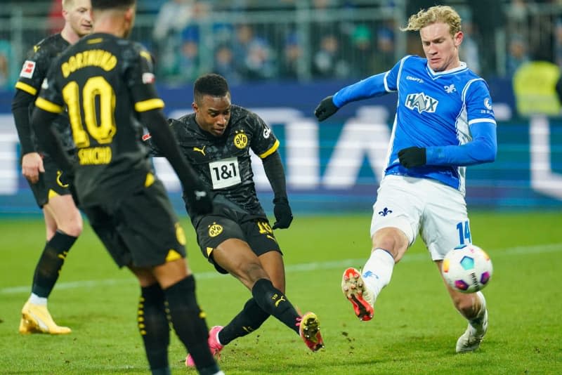 Dortmund's Youssoufa Moukoko scores his side's third goal of the game during the German Bundesliga soccer match between Darmstadt 98 and Borussia Dortmund at Merck Stadium. Uwe Anspach/dpa