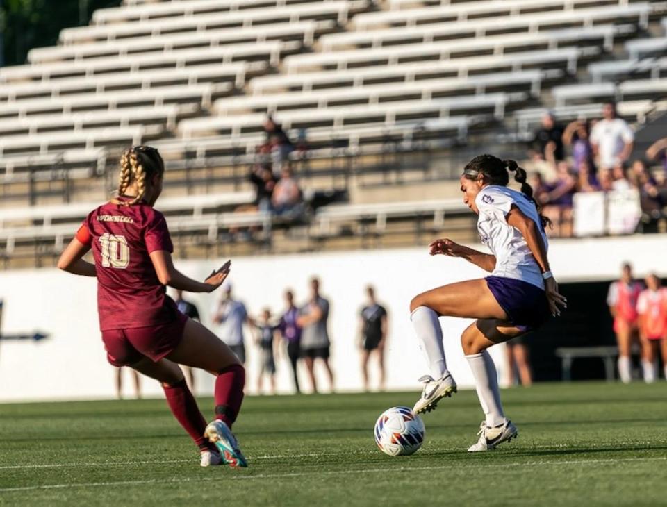 Ardrey Kell brings the ball down past her defender