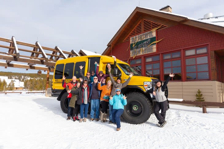 Snowcoach tour group photo in front of Old Faithful Snow Lodge in Yellowstone