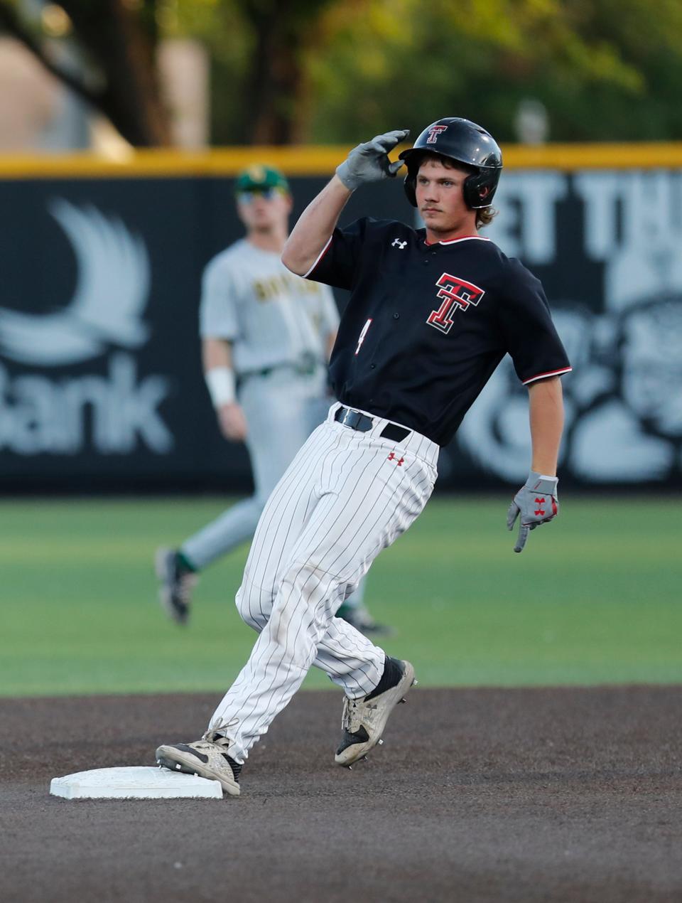 Texas Tech's Kevin Bazzell (4) is safe at second base against Baylor in game one of their Big 12 baseball game, Friday, April 21, 2023, at Dan Law Field at Rip Griffin Park.