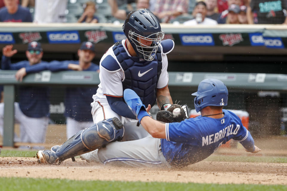 Minnesota Twins catcher Gary Sanchez tags out Toronto Blue Jays' Whit Merrifield who tags from third on a sacrifice fly by Cavan Biggio in the tenth inning of a baseball game Sunday, Aug. 7, 2022, in Minneapolis.  The play was overturned on review due to the catcher blocking the plate and the Blue Jays won 3-2 in 10. (AP Photo/Bruce Kluckhohn)