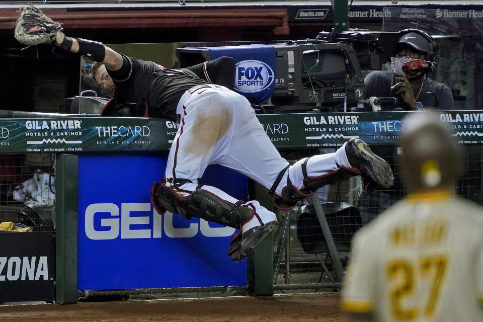 Arizona Diamondbacks catcher Carson Kelly catches a pop-up hit by San Diego Padres catcher Francisco Mejia (27) during the eighth inning of a baseball game Saturday, Aug. 15, 2020, in Phoenix. (AP Photo/Matt York)