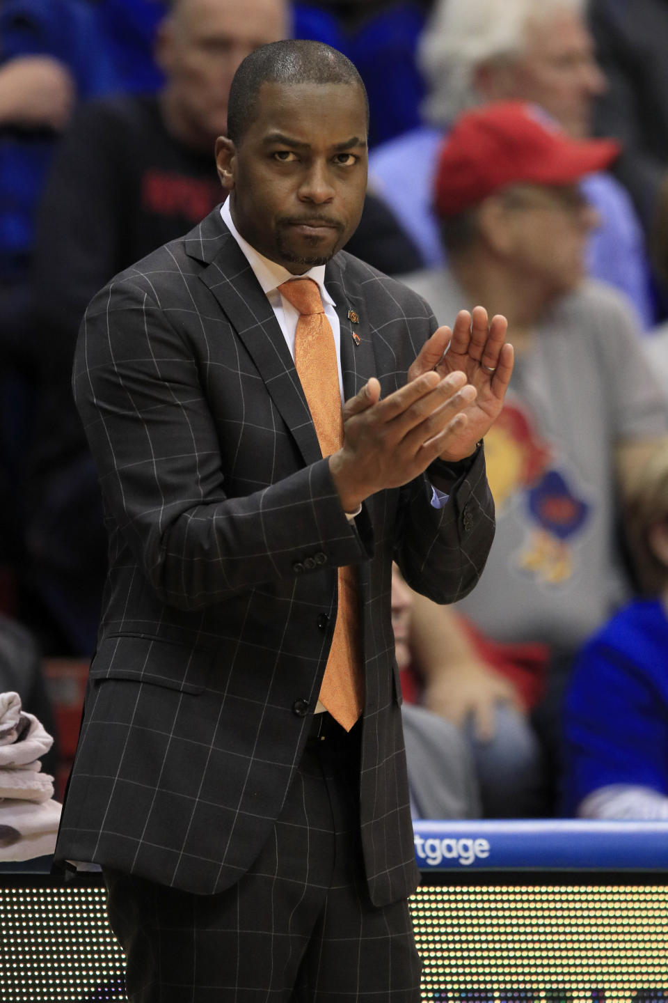 Oklahoma State head coach Mike Boynton applauds his team during the first half of an NCAA college basketball game against Kansas in Lawrence, Kan., Monday, Feb. 24, 2020. (AP Photo/Orlin Wagner)