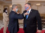 Colombian President Ivan Duque Marquez and U.S. Secretary of State Mike Pompeo bump elbows before attending a meeting at the presidential house in Bogota