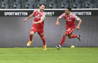 Kevin Stoeger, left, from Mainz celebrates after scoring his side second goal during the German Bundesliga soccer match between Borussia Moenchengladbach and SV Mainz 05 in Moenchengladbach, Germany, Saturday, Feb. 20, 2021. (Federico Gambarini/Pool via AP)