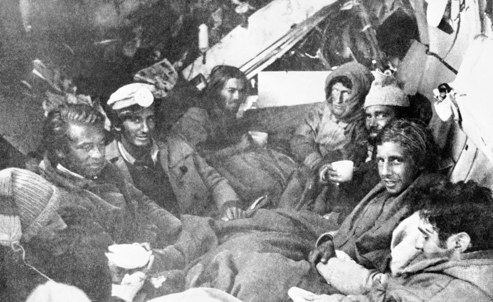 The last eight survivors of the Uruguayan Air Force plane crash in the Andes in South America, huddle together in the craft's fuselage on their final night before rescue on Dec. 22, 1972. A mountain rescue team brought them food. (AP Photo)