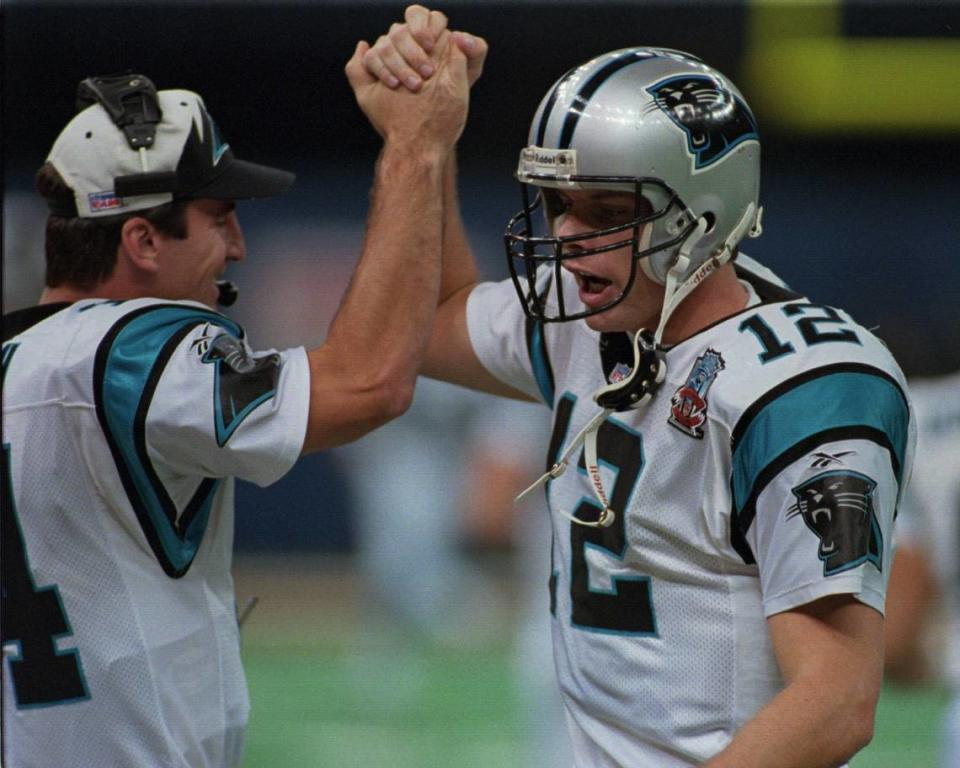 12/01/95 8B BOB LEVERONE/Staff THE GOOD TIMES: Kerry Collins (12) celebrates with backup quarterback Frank Reich after a touchdown against New Orleans on Sunday. Collins had three touchdown passes in the game, but also threw four interceptions and fumbled three times. (UNPUBLISHED NOTES:) Panther quarterback Kerry Collins is congratulated by teammate (14) Frank Reich Sun. after the teamed scored vs the New Orleans Saints. Photo By: Bob Leverone/Staff