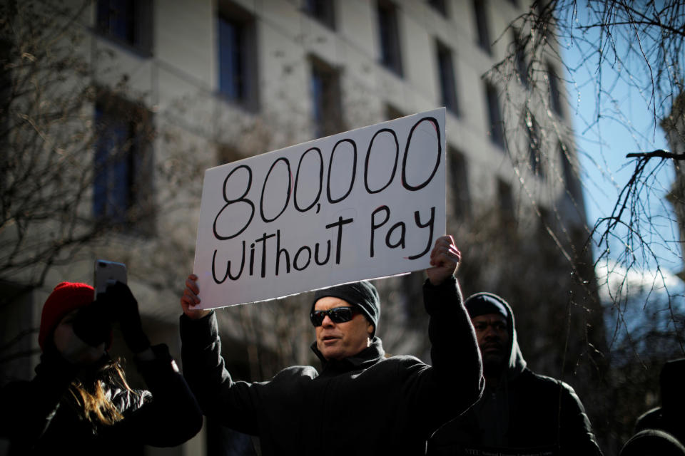 A demonstrator holds a sign, signifying hundreds of thousands of federal employees who won’t be receiving their paychecks as a result of the partial government shutdown, during a “Rally to End the Shutdown” in Washington, D.C., Jan. 10, 2019. (Photo: Carlos Barria/Reuters)