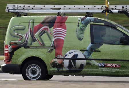 A British Sky Broadcasting Group (BSkyB) work van is driven in west London July 25, 2014. Britain's BSkyB has agreed to pay 4.9 billion pounds ($8.3 billion) in cash to buy Rupert Murdoch's pay-TV assets in Germany and Italy, responding to slowing growth at home by creating a European media powerhouse. BSkyB, in which Murdoch's 21st Century Fox is also the top shareholder, will pay for the deal using cash, debt and a placing of shares that represents around 10 percent of its issued share capital. BSkyB said it would pay 2.45 billion pounds for Sky Italia and 2.9 billion pounds for Fox's 57 percent stake in Sky Deutschland to create a group with nearly 20 million customers. REUTERS/Toby Melville