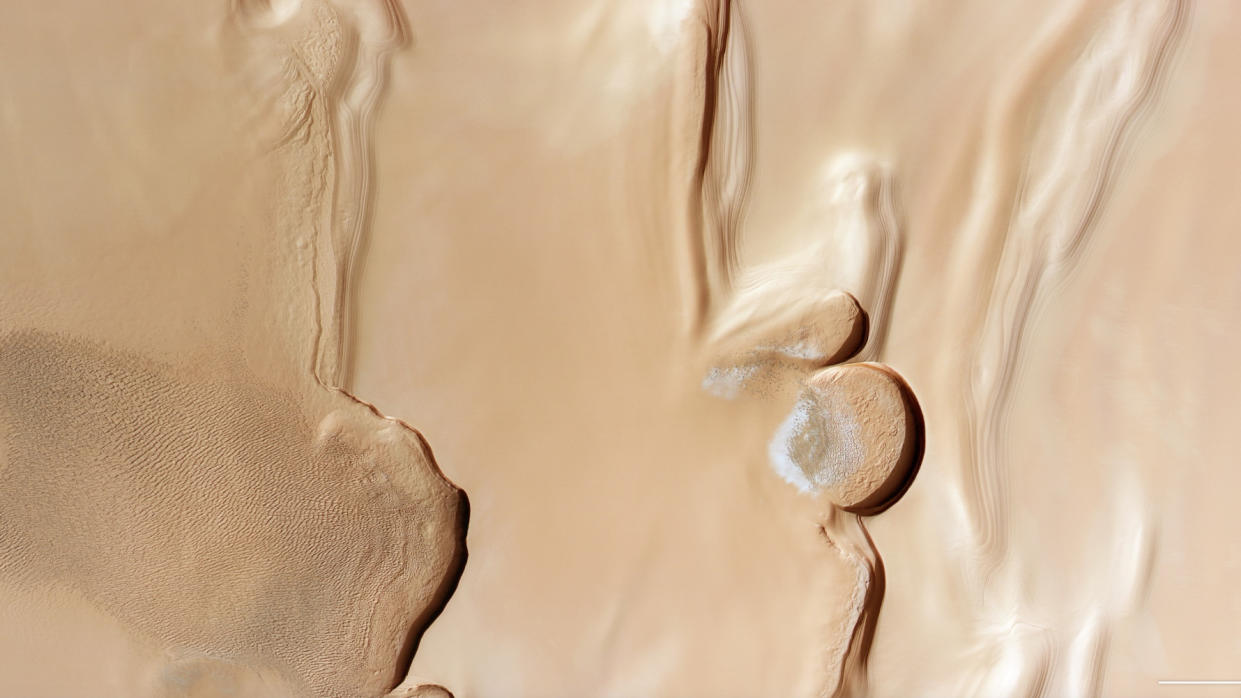  Photo from mars orbit, showing rippling sand dunes to the left and some patches of water ice to the right. 