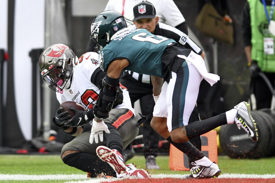 Tampa Bay Buccaneers safety Mike Edwards (32) intercepts a pass intended for Philadelphia Eagles wide receiver DeVonta Smith (6) during the first half of an NFL wild-card football game Sunday, Jan. 16, 2022, in Tampa, Fla. (AP Photo/Jason Behnken)