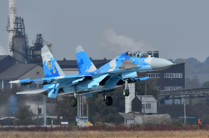 A Ukrainian Su-27 UB fighter (Combat Trainer), painted in various shades of light blue, takes off. 