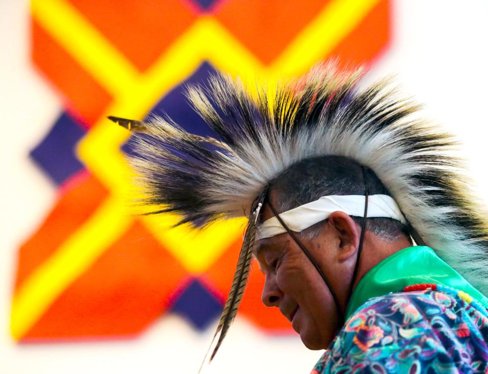 Mike Harmon of Millsboro, with the Nanticoke Indian tribe, performs during the Powwow of Arts and Culture at the Delaware Art Museum, Saturday, July 23, 2022. A Larry Holmes painting forms the backdrop. 