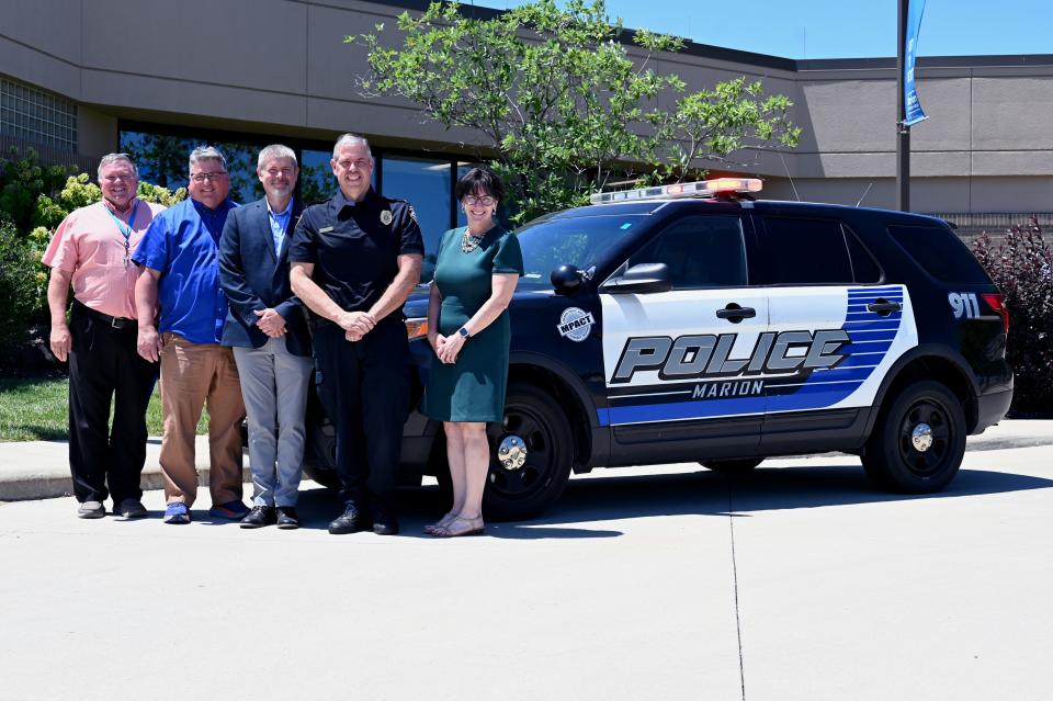 The Marion Police Department donated a cruiser to the academy so students can practice driving and traffic stop skills. Around the car are Mike Stuckey, left, Greg Perry, Dr. Ryan McCall, Chief Jay McDonald and Dr. Amy Adams.