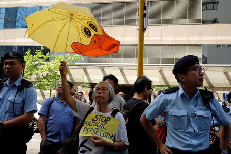 A protester supporting Occupy Central pro-democracy movement holds a placard outside a district court in Hong Kong September 19, 2017. REUTERS/Bobby Yip