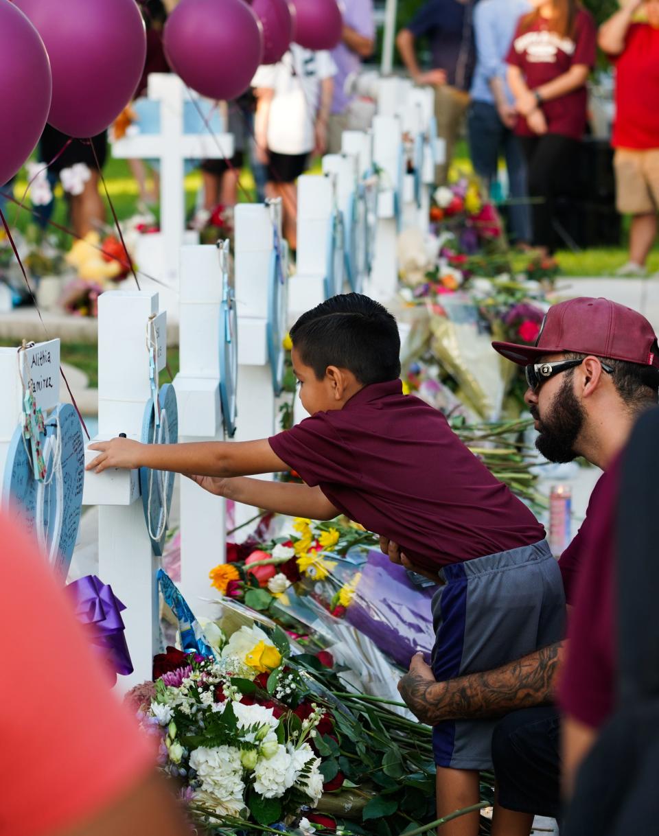 Children and adults gather to mourn May 27 in Ulvade, Texas, three days after a gunman killed 23 people at Robb Elementary School.