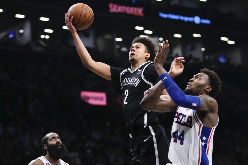 Brooklyn Nets' Cameron Johnson (2) drives past Philadelphia 76ers' Paul Reed (44) during the second half of Game 4 in an NBA basketball first-round playoff series Saturday, April 22, 2023, in New York. (AP Photo/Frank Franklin II)