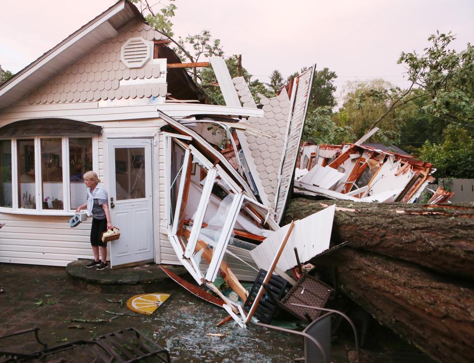 Joan Visbal leaves her home in North Salem, New York after retrieving a few personal items shortly after a large tree crushed half of her home while she was in it Sunday evening June 23, 2024. A powerful storm hit the Northern Westchester/Putnam area taking down many trees, utility poles and wires.