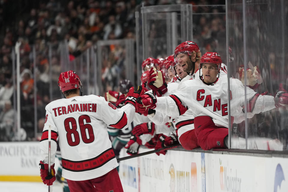 Carolina Hurricanes' Teuvo Teravainen (86) is greeted by teammates after scoring a goal against the Anaheim Ducks during the second period of an NHL hockey game, Sunday, Oct. 15, 2023, in Anaheim, Calif. (AP Photo/Jae C. Hong)