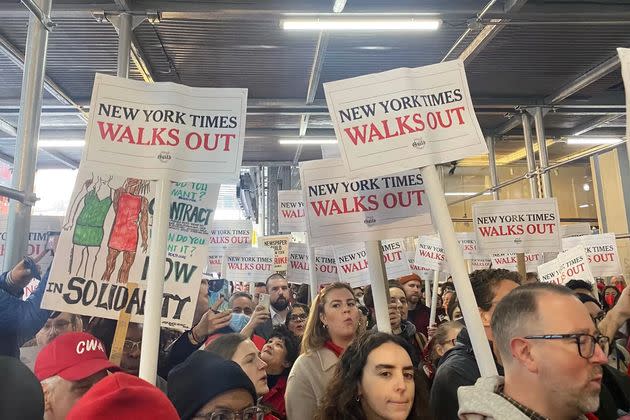 Hundreds of reporters and workers of The New York Times formed a picket line outside their Times Square building as contract negations stalled.