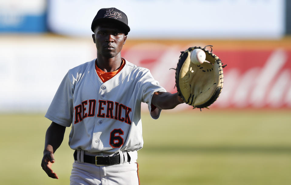 Frederick Keys catcher Dennis Kasumba warms up for the team's baseball game against the Trenton Thunder, Tuesday, July 4, 2023, in Trenton, N.J. Kasumba, from Uganda, dreams of reaching the major leagues someday. The 19-year-old catcher had a chance to play for the Frederick Keys of the MLB Draft League this past month. (AP Photo/Noah K. Murray)