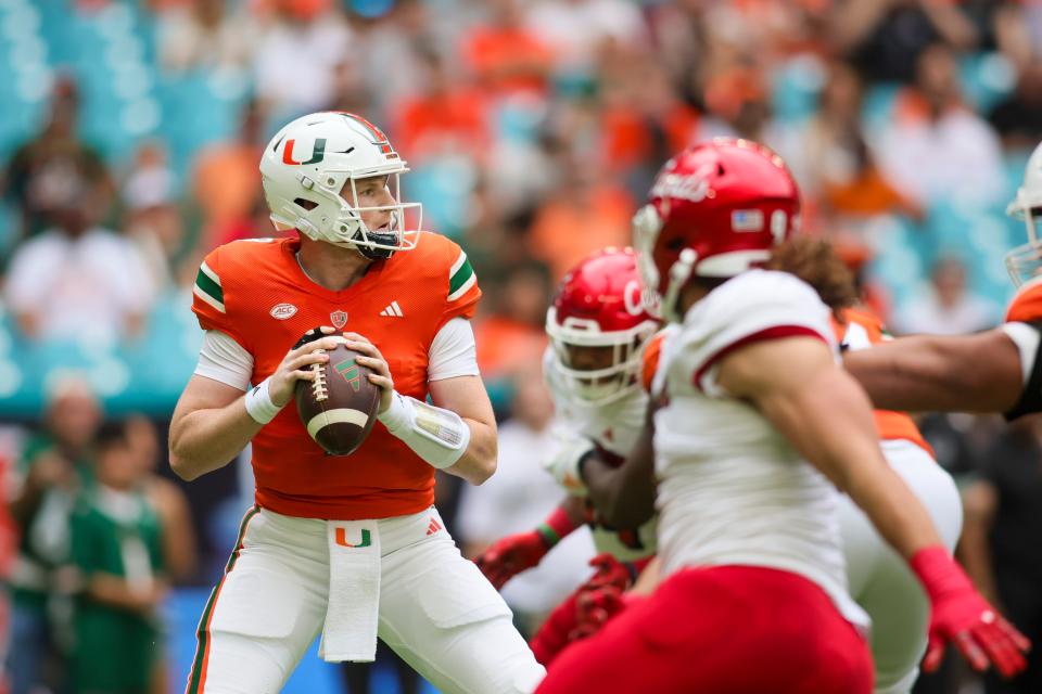 Nov 18, 2023; Miami Gardens, Florida, USA; Miami Hurricanes quarterback Tyler Van Dyke (9) looks to pass against the Louisville Cardinals during the first quarter at Hard Rock Stadium. Mandatory Credit: Sam Navarro-USA TODAY Sports