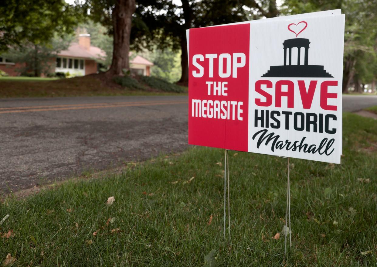 A Stop the Megasite sign one of many that can be found around Marshall in the front lawn of Diane and Glenn Kowalske's home in Marshall on Wednesday, July 12, 2023. The Kowalske's are two of many in the small town not happy with Ford Motor Company moving forward on their EV battery plant.