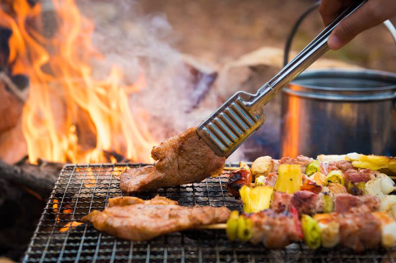 Close up grilling barbecue in the campground at summer camp travel, Skewers of pork and beef fillet on barbecue party in camping, Summer Camp Travel one activity for relaxing.