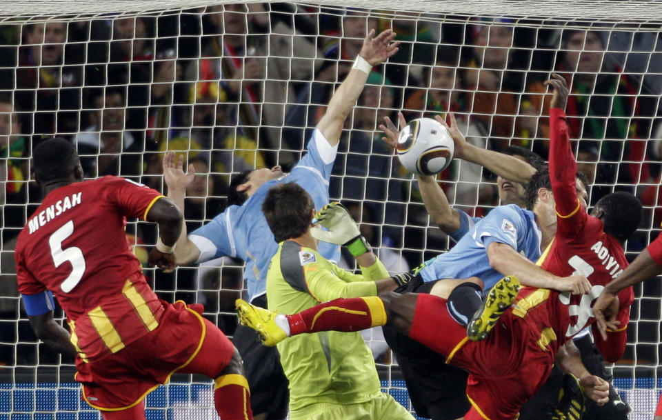 FILE - Uruguay's Luis Suarez, right, stops the ball with his hands to give away a penalty kick during the World Cup quarterfinal soccer match between Uruguay and Ghana at Soccer City in Johannesburg, South Africa, Friday, July 2, 2010. (AP Photo/Fernando Vergara, File)