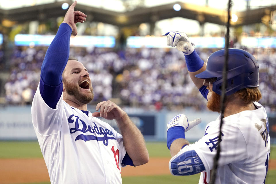 Los Angeles Dodgers' Justin Turner, right, celebrates his solo home run with Max Muncy during the first inning of a baseball game against the San Francisco Giants Monday, July 19, 2021, in Los Angeles. (AP Photo/Mark J. Terrill)