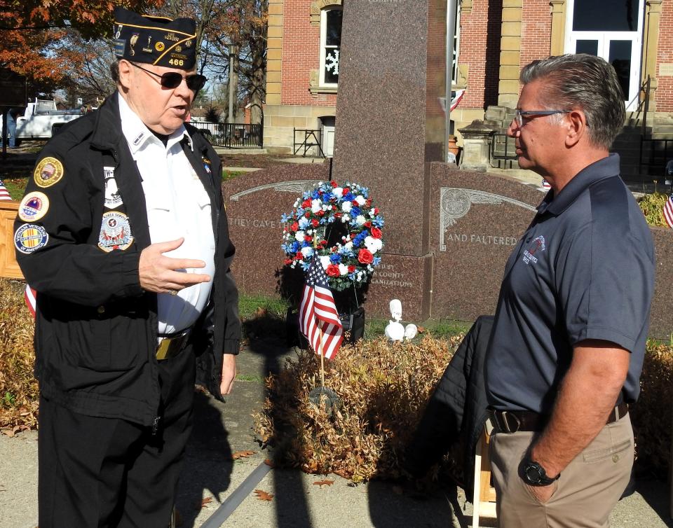 Jack Patterson, who was recently inducted in the Ohio Veterans Hall of Fame talks with Coshocton County Veterans Service Officer Doug Schaefer prior to the annual Veterans Day ceremony on the Coshocton Court Square.