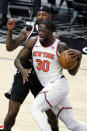 New York Knicks forward Julius Randle drives past Los Angeles Clippers forward Marcus Morris Sr. during the second half of an NBA basketball game Sunday, May 9, 2021, in Los Angeles. (AP Photo/Marcio Jose Sanchez)