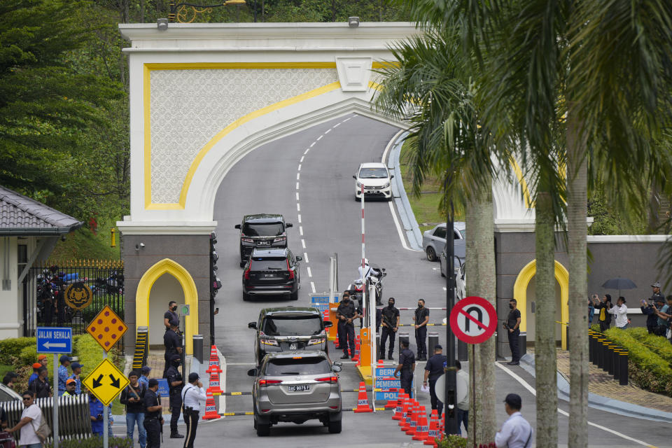 A representative from Barisan National (BN) arrives by car at National Palace in Kuala Lumpur, Malaysia to meet with King Sultan Abdullah Sultan Ahmad Shah Wednesday, Nov. 23, 2022. Malaysia's king on Tuesday failed to reach a decision on whom to pick as prime minister after meeting the leaders of two rival blocs, and summoned lawmakers from a political bloc that has held out its support. (AP Photo/Vincent Thian)