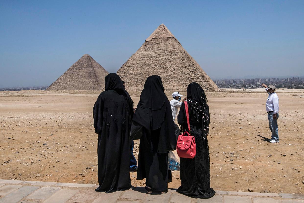 Yemeni women residing in Egypt visit the Giza Pyramids necropolis on the southwestern outskirts of Cairo, Egypt's capital, on July 1, 2020 as the country eases restrictions put in place due to the coronavirus pandemic. A spree of openings in Egypt comes after the country officially ended a three-month nighttime curfew a few days earlier.