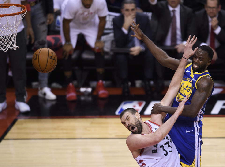 Toronto Raptors centre Marc Gasol #33 fouls Golden State Warriors forward Draymond Green #23 during second half Game 5 NBA Finals basketball action in Toronto on Monday, June 10, 2019. (Photo by The Canadian Press/Nathan Denette)