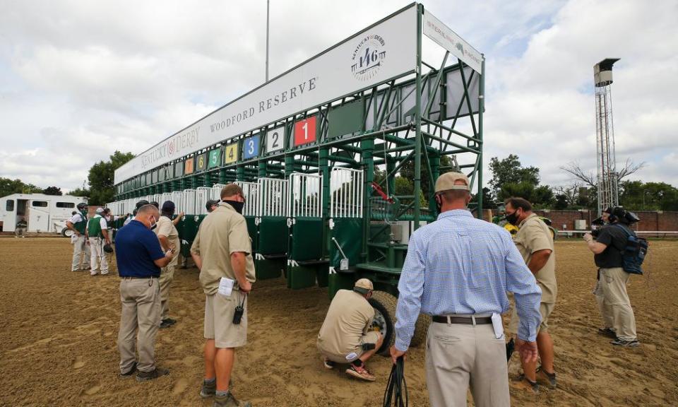 Workers prepare a new starting gate at Churchill Downs.