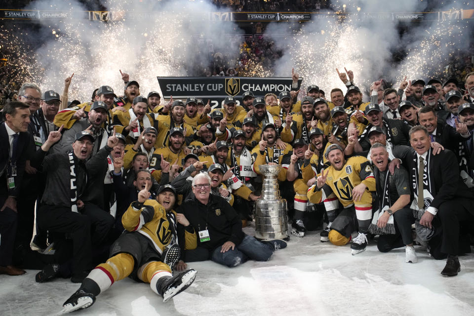 Members of the Vegas Golden Knights pose with the Stanley Cup after the Knights defeated the Florida Panthers 9-3 in Game 5 of the NHL hockey Stanley Cup Finals Tuesday, June 13, 2023, in Las Vegas. The Knights won the series 4-1. (AP Photo/John Locher)