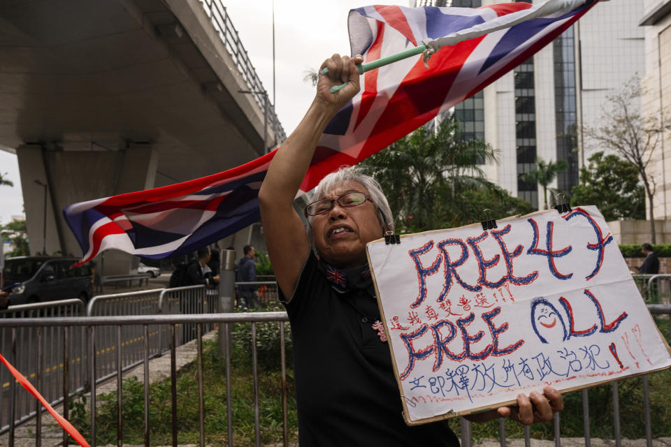 A pro-democracy activist known as "Grandma Wong" protests outside the West Kowloon courts in a cordoned off area set up by police as closing arguments open in Hong Kong's largest national security trial of 47 pro-democracy figures in Hong Kong, Wednesday, Nov. 29, 2023. (AP Photo/Louise Delmotte)