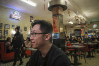 In this Feb. 13, 2020, photo, Vincent Tang, manager of Manhattan's Chinatown oldest restaurant, Nom Wah Tea Parlor, speaks during an interview at the establishment started by his father, in New York. The restaurant has seen a 40% drop in business over the past three weeks, said Tang. "We're lucky to have loyal customers." (AP Photo/Bebeto Matthews)