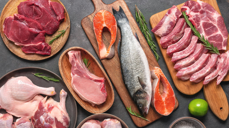 Raw meats and fish displayed on slate