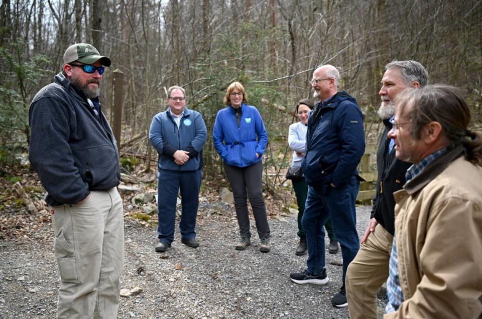 Rothrock State Forest District forester Mark Potter (far left) talks to a group as they visit the Musser Gap Trail on Thursday.