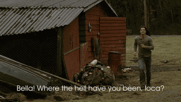 Jacob Black stands by a motorcycle, looking concerned, in a scene from Twilight