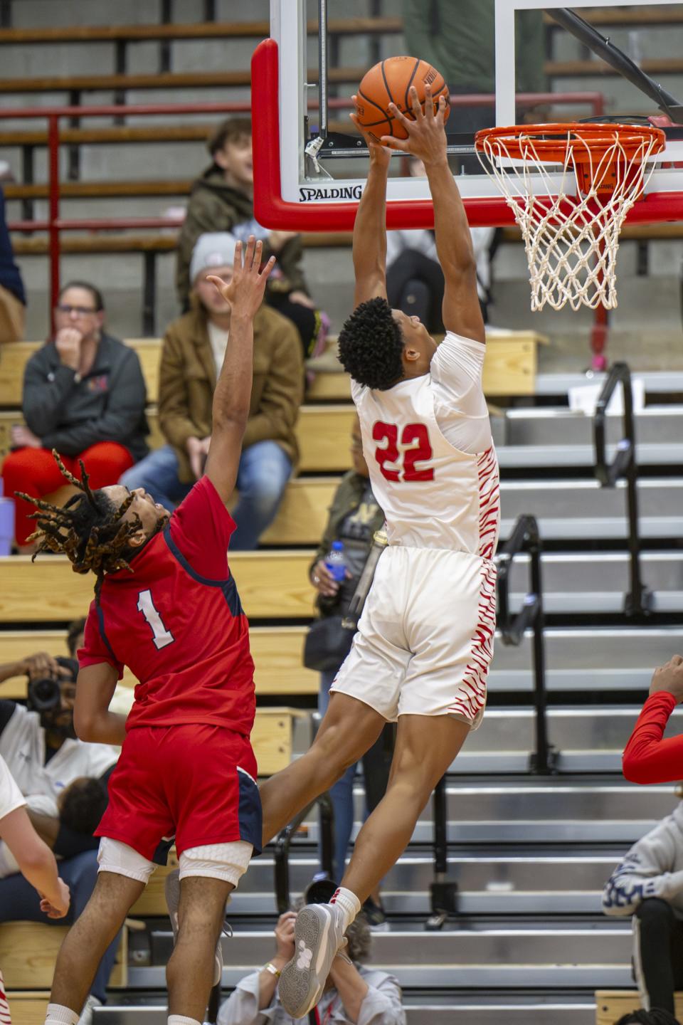 Fishers High School junior JonAnthony Hall (22) scores with a slam dunk after making a move around Kokomo High School junior Zion Bellamy (1) during the second half of a game in the Forum Tipoff Classic, Saturday, Dec. 9, 2023, at Southport High School.