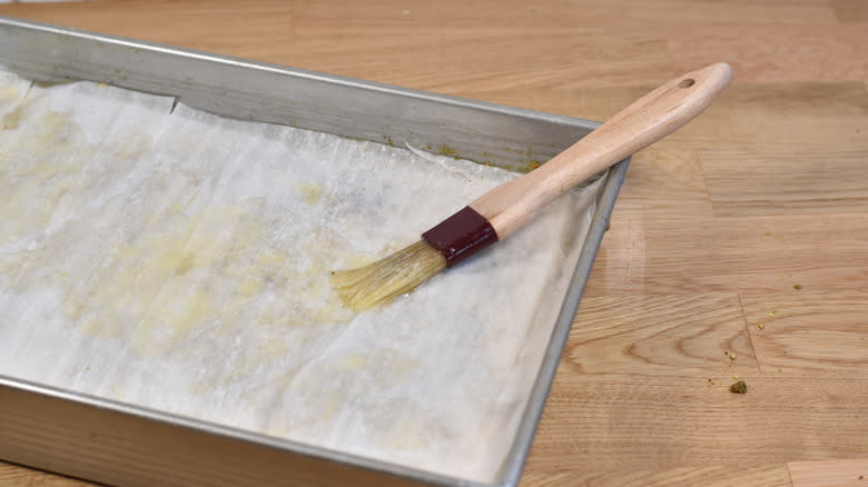brushing phyllo dough with butter
