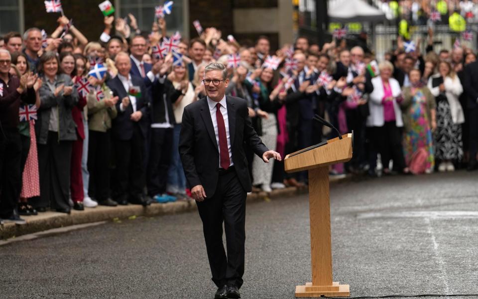 Britain's Labour Party Prime Minister Keir Starmer walks back after speaking to the media and supporters supporters in London