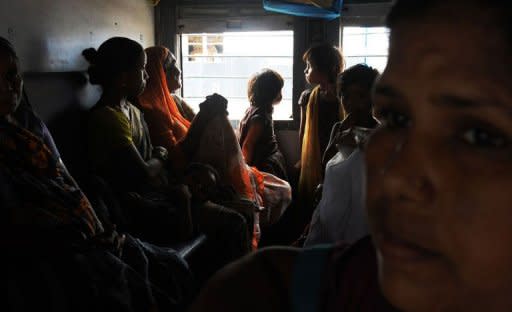 Indian women and children waiting inside a train carriage at a railway station in New Delhi, in July 2012. Deadly floods, power blackouts and traffic gridlock, many of Asia's biggest cities are buckling under the strain of rapid economic development, extreme weather and an exodus from the countryside