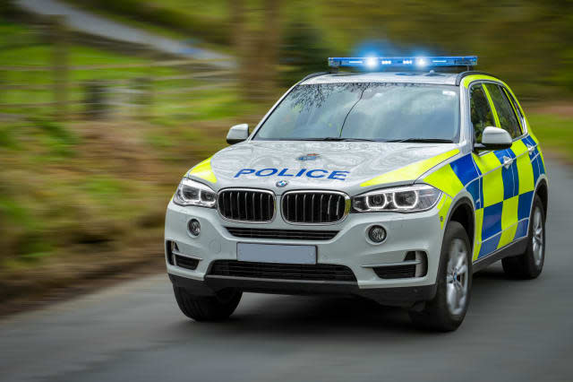 A police car speeds to an emergency.