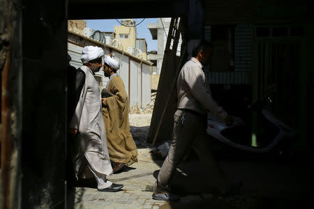 A Shi'ite cleric walks to a religious school run by al-Hawza al-Ilmiyya in Najaf, Iraq, August 13, 2017. For more than 1,000 years, the al-Hawza al-Ilmiyya in southern Baghdad has been giving religious instructions to thousands of Shi'ite Muslims to help them become clerics. REUTERS/Abdullah Dhiaa Al-deen