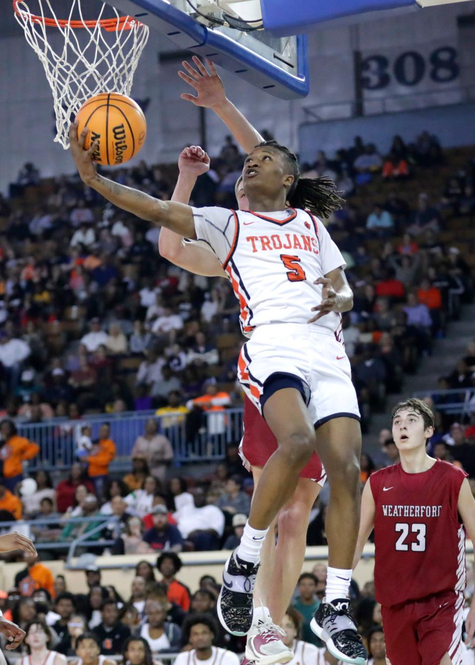 Douglass' James Greenhoward (5) goes up for a layup as Weatherford's Nate Reherman (15) defends during the Class 4A state championship game Saturday at the State Fair Arena.